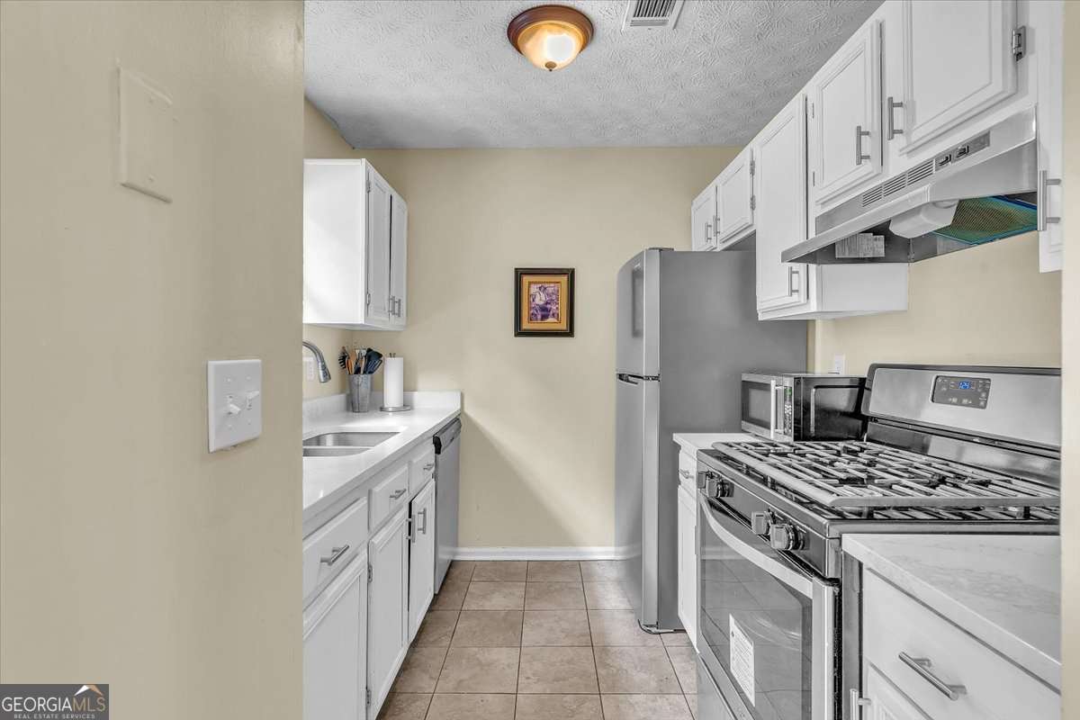 3 bedroom, 2 bathroom, 1,324 sq ft single family residence for sale at 5300 Forest Downs Lane, Atlanta, GA 30349 — photo 8
