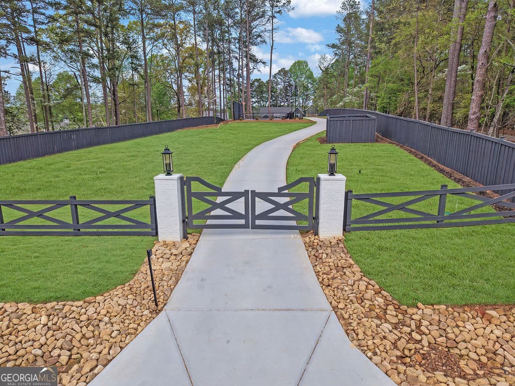 7 bedroom, 6.5 bathroom, 6,434 sq ft single family residence for sale at 6093 Shadburn Ferry Road, Buford, GA 30518 — photo 3