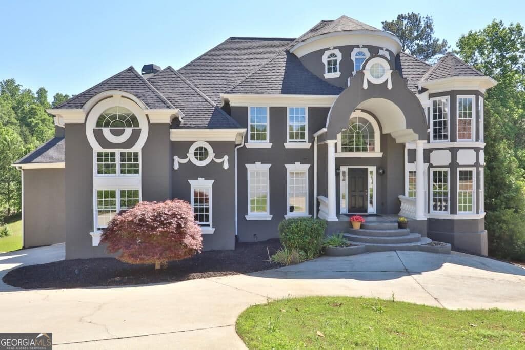 6 bedroom, 5.5 bathroom, 5,959 sq ft single family residence for sale at 910 Woodward Park Drive, Suwanee, GA 30024 — photo 1 of 97