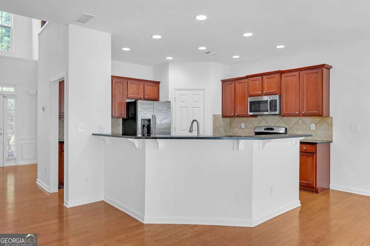 5 bedroom, 3 bathroom, 2,472 sq ft single family residence for sale at 5608 Avonley Creek Drive, Sugar Hill, GA 30518 — photo 5
