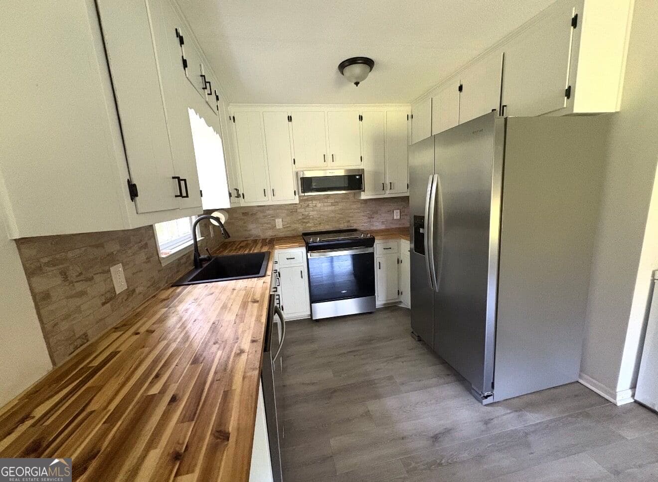 3 bedroom, 2 bathroom, 1,558 sq ft single family residence for sale at 1468 Highway 41, Milner, GA 30257 — photo 4