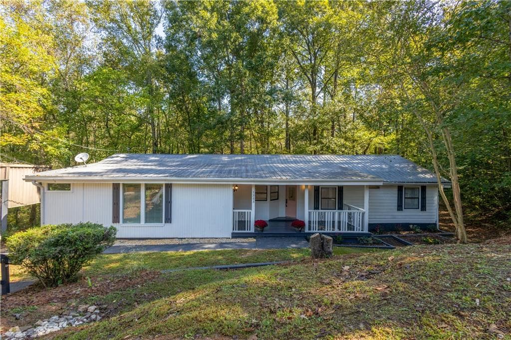 4 bedroom, 3 bathroom single family residence sold at 1355 Woodland Drive, Oxford, GA 30054