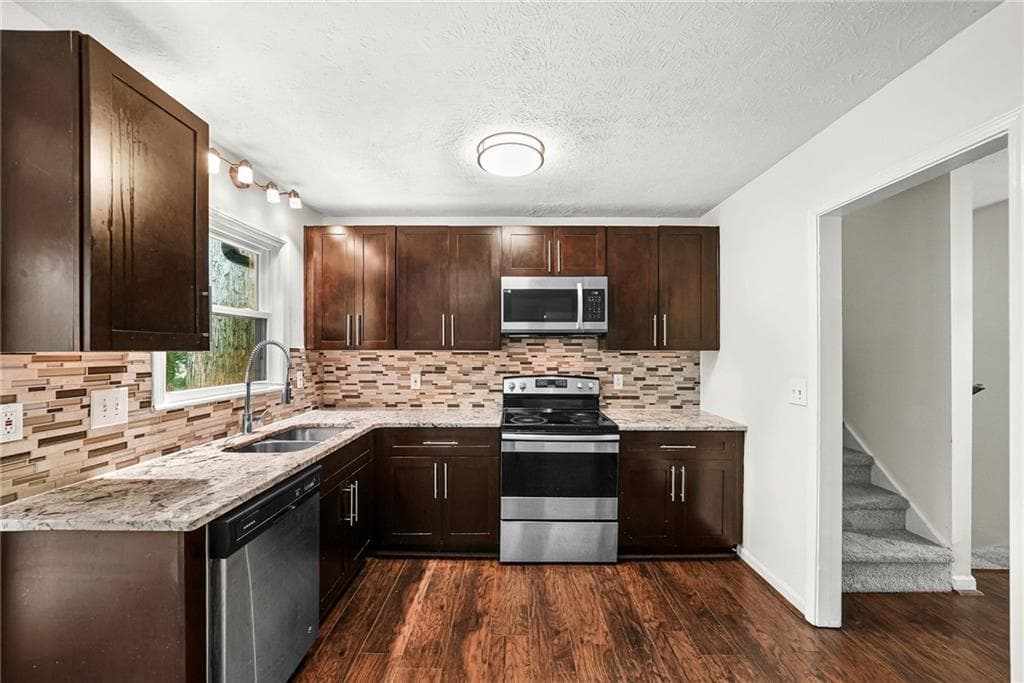 4 bedroom, 3 bathroom, 1,966 sq ft single family residence for sale at 1469 W Rock Court, Stone Mountain, GA 30088 — photo 2