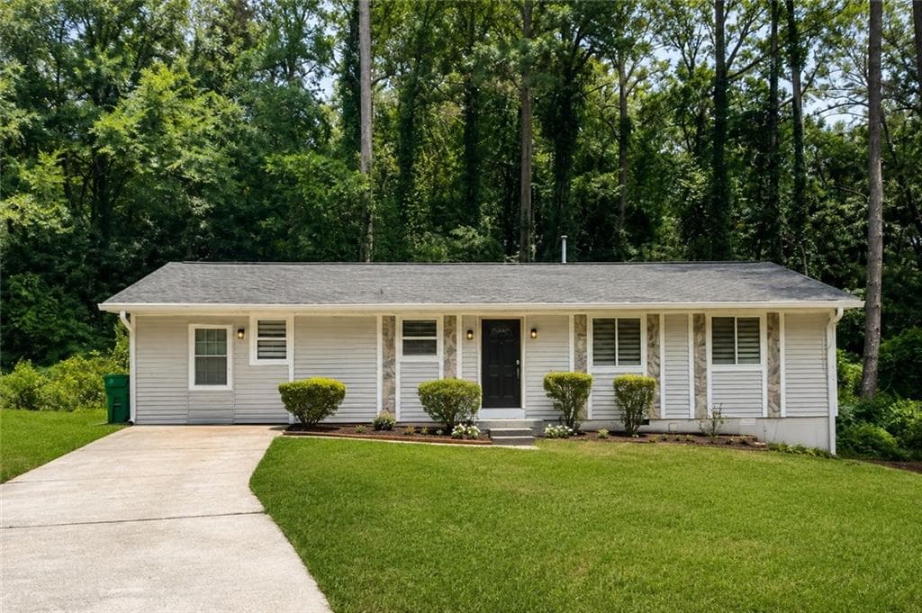4 bedroom, 3 bathroom, 1,456 sq ft single family residence for sale at 4091 Big Valley Trail, Stone Mountain, GA 30083 — photo 1 of 27