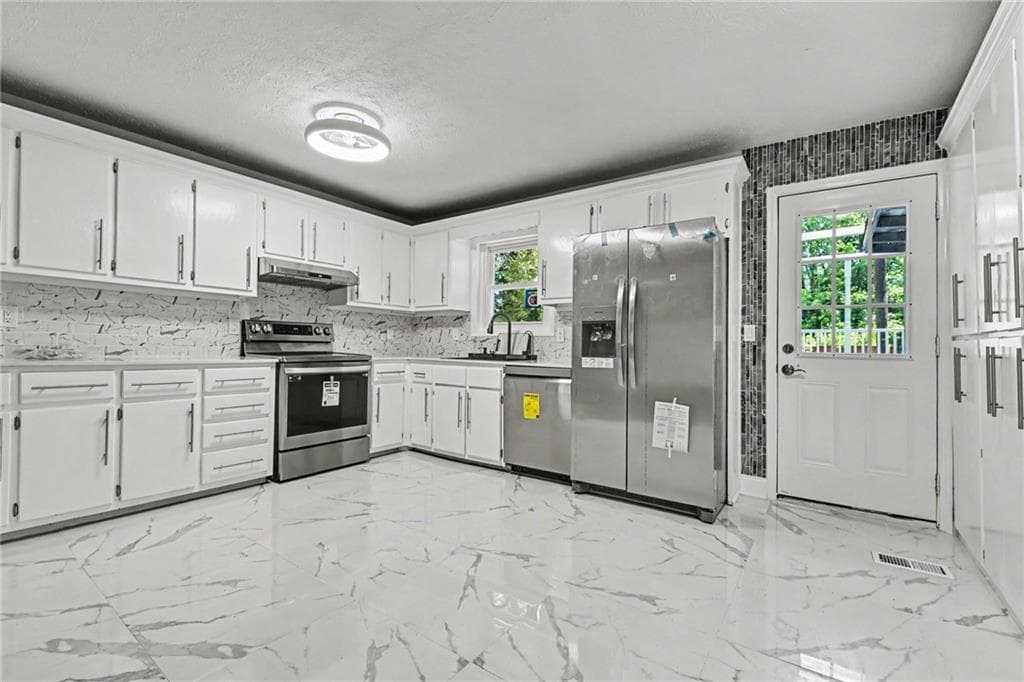 6 bedroom, 3 bathroom single family residence for sale at 7348 Mockingbird Trail, Riverdale, GA 30274 — photo 9